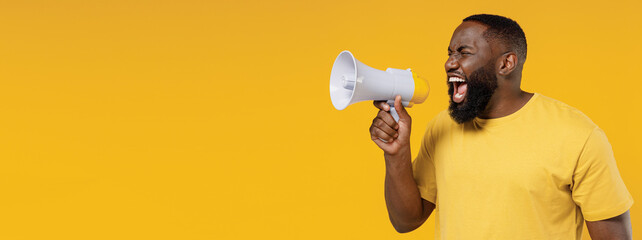 Young black man 20s wearing bright casual t-shirt hold scream shout in megaphone announces...