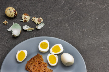 Boiled egg halves and toast on gray plate.