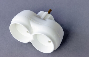 Dual-branch socket adapter on a gray background