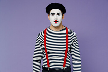 Irritated dissatisfied frowning angry nervous displeased sad young mime man with white face mask...