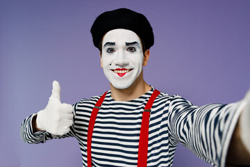 Close up young mime man with white face mask wears striped shirt beret do selfie shot pov on mobile...