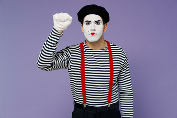 Strict nervous displeased irritated concerned young mime man with white face mask wears striped shirt beret making knocking gesture isolated on plain pastel light violet background studio portrait.