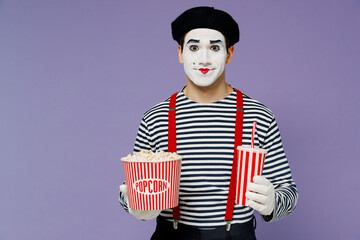 Charismatic amazing marvelous vivid young mime man with white face mask wear striped shirt beret old bucket of popcorn cup of soda pop isolated on plain pastel light violet background studio portrait