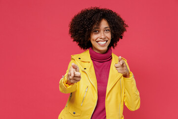 Confident leader charming smiling young curly black latin woman 20s years old wear yellow jacket point index finger camera on you motivating encourage isolated on plain red background studio portrait