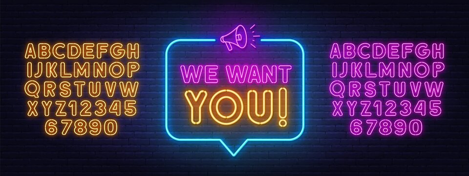 We want you neon sign in the speech bubble on brick wall background.