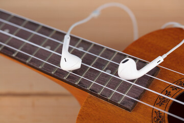 Fototapeta premium Headphones on Ukulele Strings