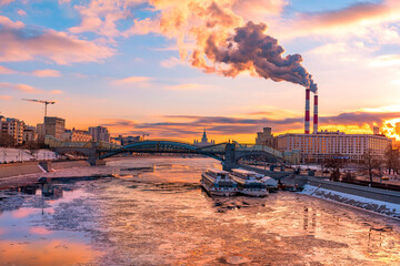 Winter Moscow river scenery. Beautiful Sunset under icebreak Moscow river on dramatic sky. Russia,...