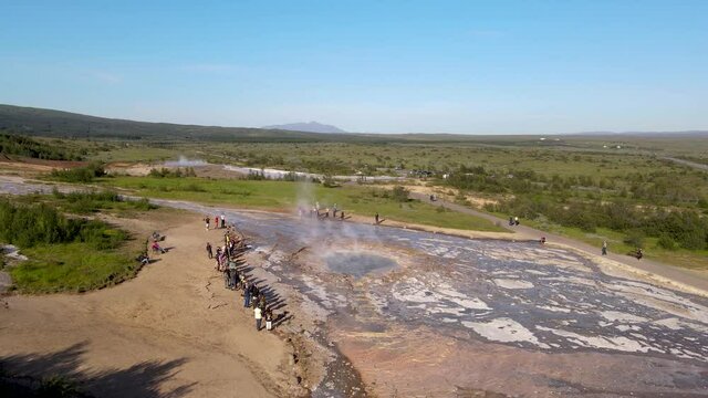 Aerial Cinematic footage of the Impressive Icelands Geysir Geisir in the Golden Circule, the geothermal activity and a attraction for tourists in Iceland	