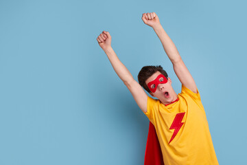 Excited superhero man with raised arms