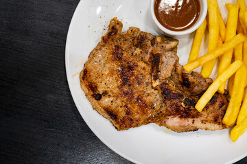 Grilled steaks, baked potatoes and vegetable salad