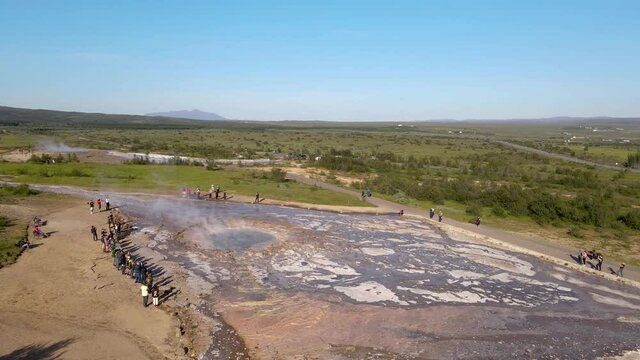 Aerial Cinematic footage of the Impressive Icelands Geysir Geisir in the Golden Circule, the geothermal activity and a attraction for tourists in Iceland	