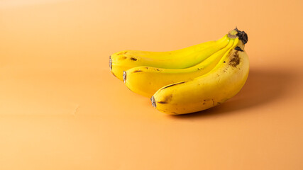 Banana bunch on large beige background for banner.Copy space