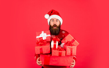 Christmas is time for giving. new year shopping discounts. bearded santa claus in hat. celebrate the party. ready for xmas presents. Christmas party time. mature man in sweater red background