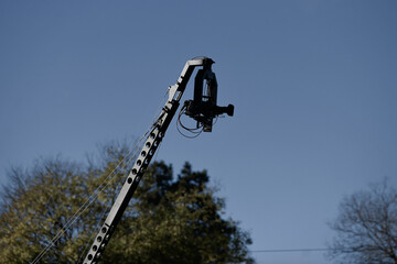 Television camera used for live broadcast hanged from above on an arm crane setup