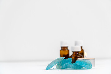 sea salt,candle and aromatic oils in bottles on a white background. Accessories for massage in the...
