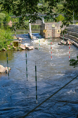 Canoe Kayak Slalom. Hanging green and red gates over a whitewater flow. Vertical image. 