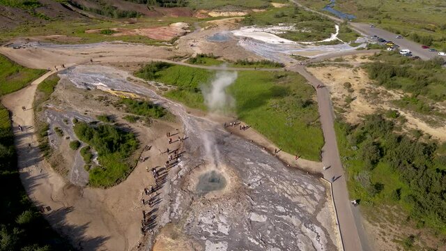 Aerial Cinematic footage of the Impressive Icelands Geysir Geisir in the Golden Circule, the geothermal activity and a attraction for tourists in Iceland	