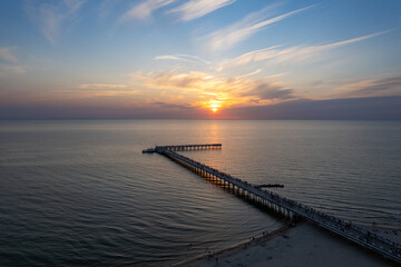 Fototapeta premium Aerial summer sunset view of sunny resort Palanga, Lithuania. Baltic sea, Palanga Bridge - Pier