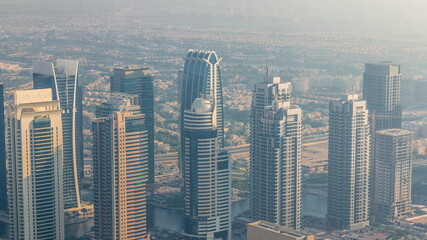 JLT skyscrapers near Sheikh Zayed Road aerial timelapse. Residential buildings and villas behind