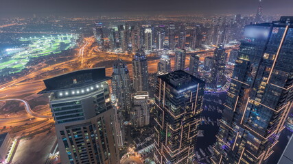 Fototapeta na wymiar Panorama of Dubai Marina with JLT skyscrapers and golf course night timelapse, Dubai, United Arab Emirates.