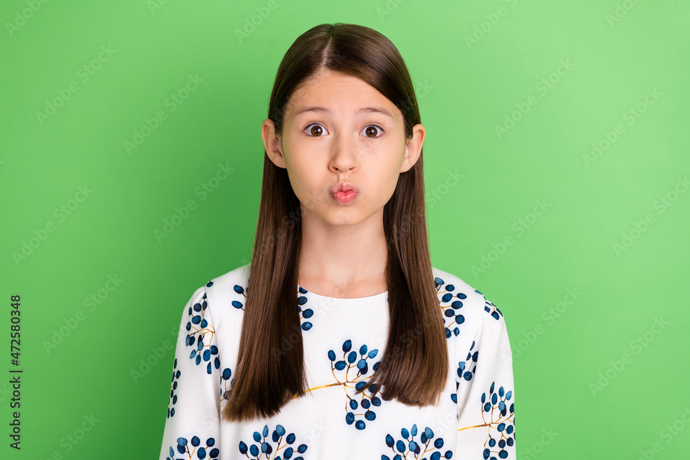 Sticker Portrait of pretty funny schoolkid girl send air kiss wear white dress outfit isolated over green color background