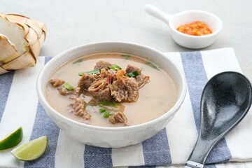 Coto Makassar, traditional food from Makassar, South Sulawesi. made from beef offal mixed with beef, seasoned with specially formulated spices. Usually served with Burasa or Ketupat ( rice cake ).

