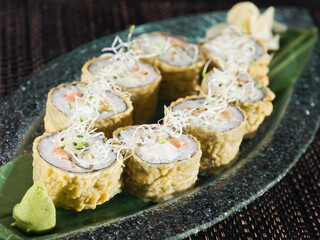 breeding hot sushi roll with salmon and avocado