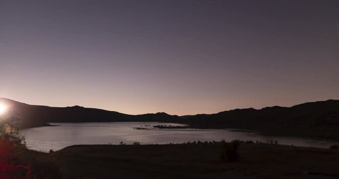 Timelapse video of helicopters flying over a lake at night in California
