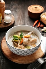 Garang Asem Ayam is Indonesian traditional food, processed chicken dishes cooked using banana leaves and dominated by sour and spicy flavors.  Served in a bowl. Selective focus image