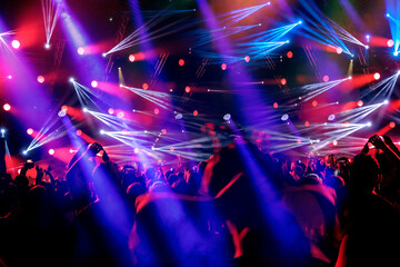 Crowd of people on the dance floor pink and blue lights
