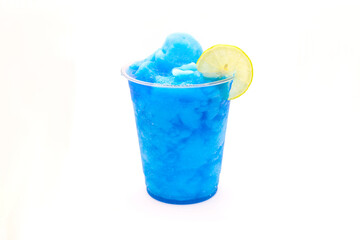Electric blue lagoon slush lemonade with a slice of lemon in a disposable cup.