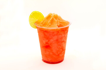 Strawberry slush with lemon slice served in a disposable cup.