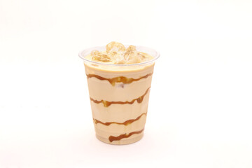 Caramel iced latte served in a disposable coffee cup.