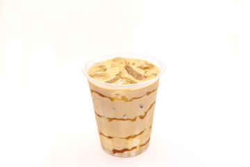 Caramel iced latte served in a disposable coffee cup.