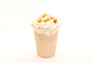 Hazelnut flavoured frappe served in a plastic cup with whipped cream and dressing.