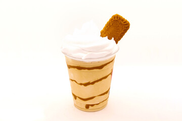 Flavoured milk shake with biscuit in a disposable plastic cup