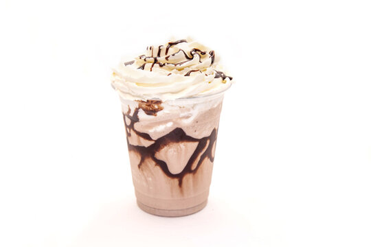 Mocha flavoured frappe served in a plastic cup with whipped cream with drizzling chocolate syrup.