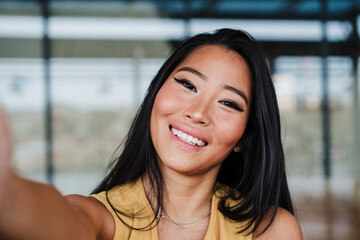 Female professional taking selfie at office