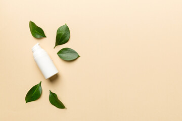 Organic cosmetic products with green leaves on color background. Copy space, flat lay