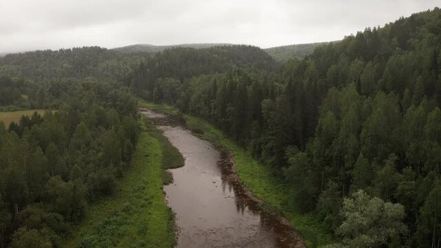 Aerial view of beautiful river Inzer at South Ural surrounded by coniferous forest at summer time
