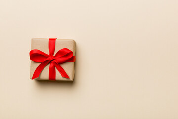 Valentine day composition: red gift box with bow and heart. Christmas present. View from above. Space for text. Holday greeting card