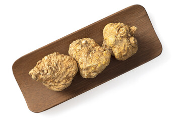 Dried yellow Maca in the wooden plate, isolated on white background, top view