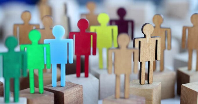 Multicolored wooden figurines of people slow motion 4k movie