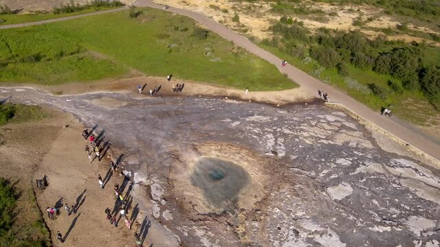 Aerial Cinematic footage of the Impressive Icelands Geysir Geisir in the Golden Circule, the geothermal activity and a attraction for tourists in Iceland	