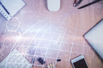 Double exposure of map hologram drawing over desktop. Top view. International connection concept.