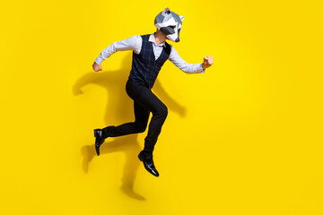 Fototapeta na wymiar Full length profile side photo of weird absurd guy racoon mask jump run rush isolated over bright yellow color background