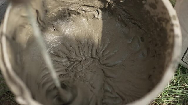 Mixing cement in a bucket