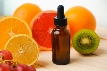 Dropper bottle filled with citrus oil. Juicy ripe citrus fruit slices. lemon. Orange. Grapefruit. Grape. Skin care. Organic, bio cosmetics healthy concept
