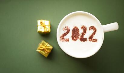 Cup of coffee 2022 top view. Happy New year. Gift boxes 