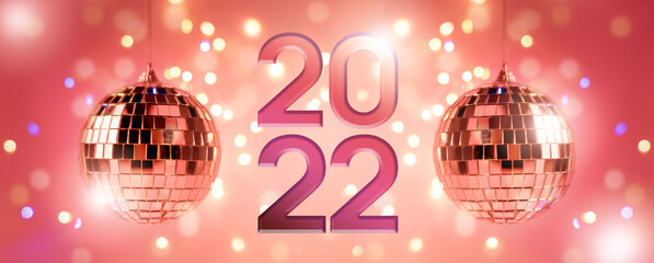 Happy New Year party background backdrop with Disco ball and number 2022 against pink coral color...